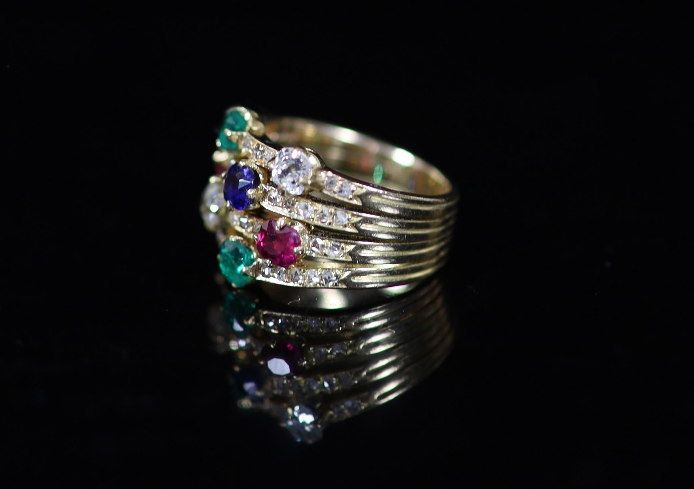 A gold, emerald, ruby, sapphire and diamond set quadruple shank dress ring
